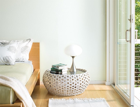 Bright, airy bedroom with white walls and a low profile bed Bright, airy bedroom with white walls and a low profile bed